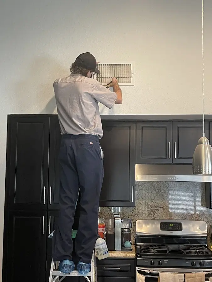 Technician inspecting an air vent during HVAC service in Steelton